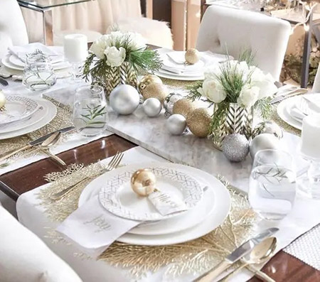 a glam and elegant Christmas tablescape with gold glitter and silver ornaments gold placemats